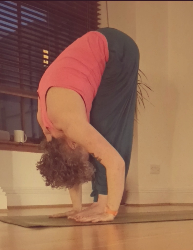 person in bent over yoga pose